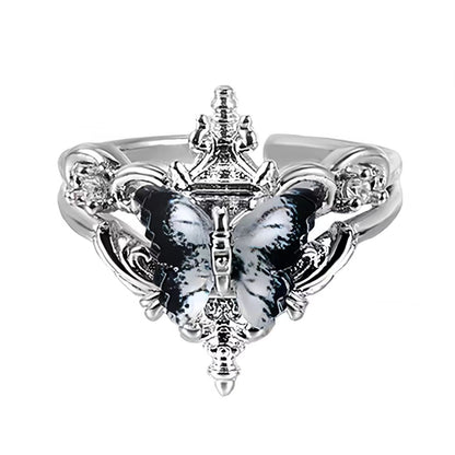 Silver ring with butterfly design on a black background