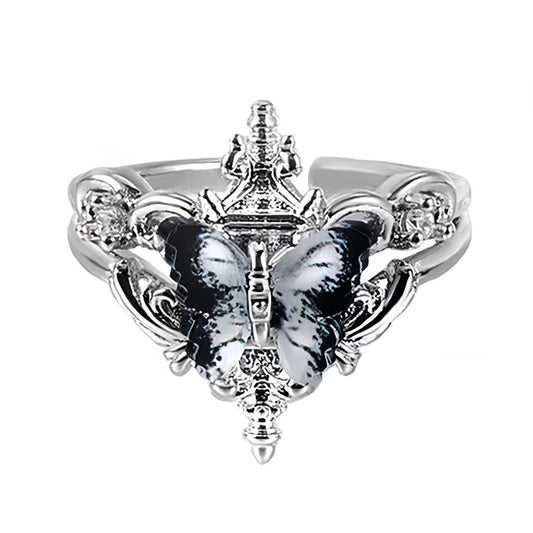 Silver ring with butterfly design on a black background